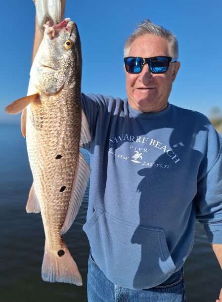 Angler holding up his redfish catch